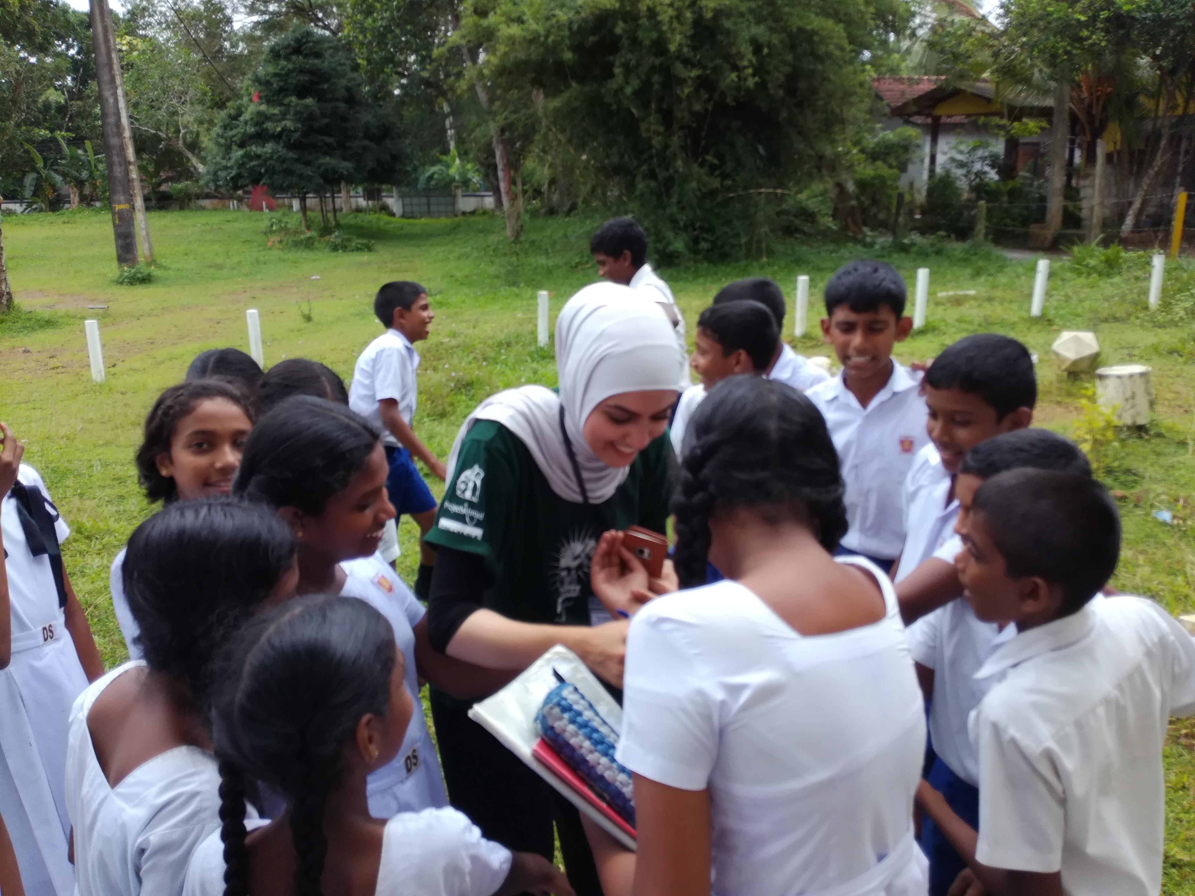 Interns greeting children at a medical outreach as part of their nursing internship in Sri Lanka with Projects Abroad. Projects Abroad intern is pictured greeting a group of children at a medical outreach during her nursing internship in Sri Lanka.